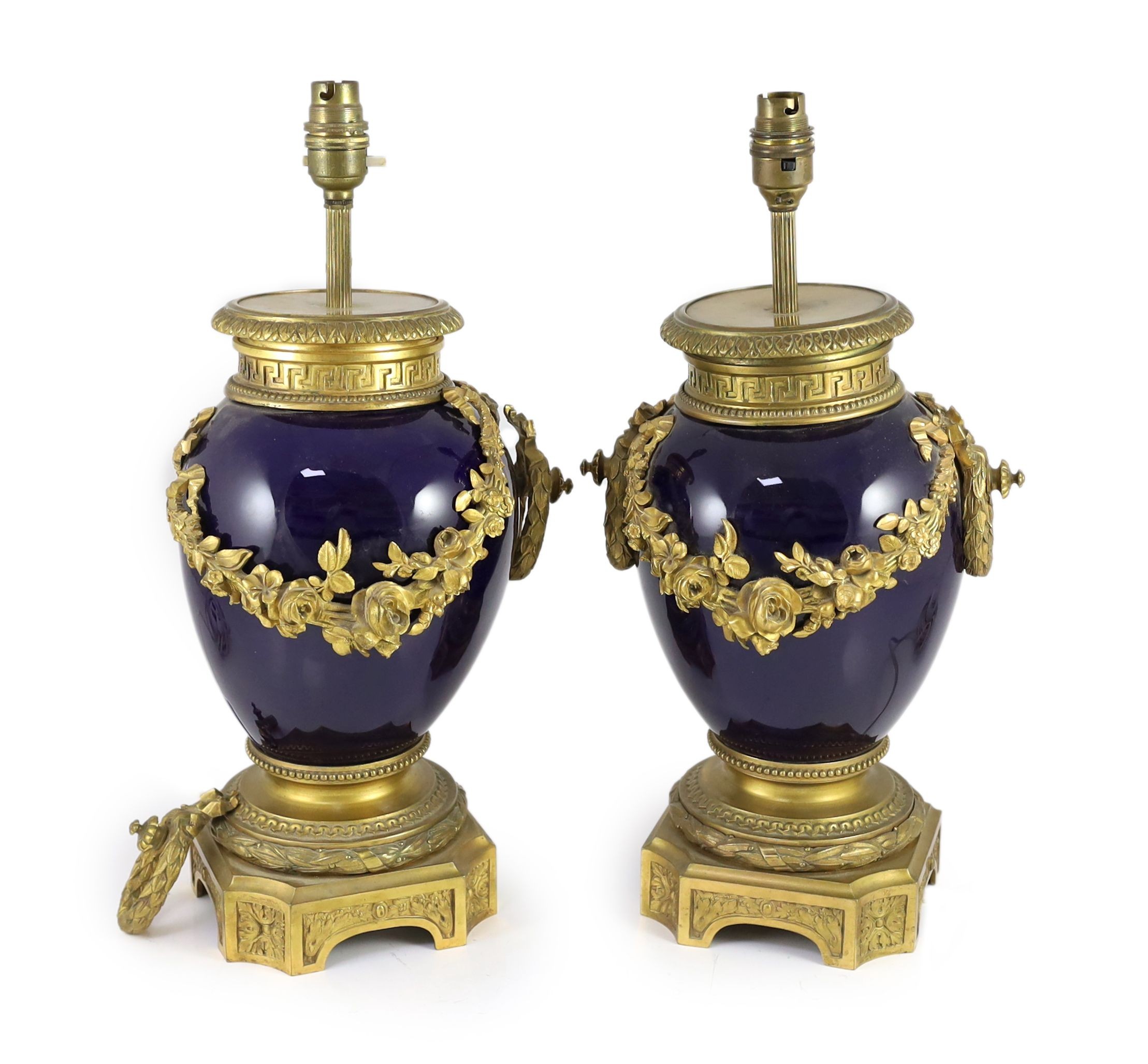 A pair of Louis XVI style ormolu mounted bleu du roi porcelain table lamps, width 23cm height 40cm